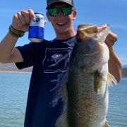 American angler shows off a nice largemouth bass caught in the Picachos lake.